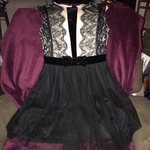 The brand is Mystic and it’s a black/cream lace dress with velvet